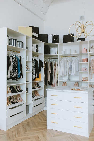 Neatly organized shelves spanning the walls of a walk-in closet